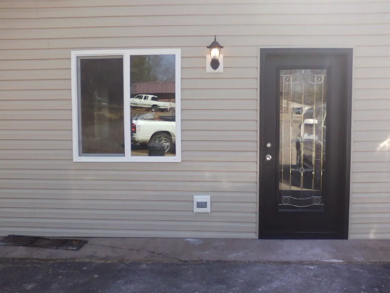 New siding, window and entry door on the side of an addition in Westover